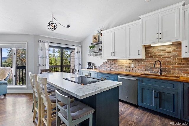 100 County Road 8344 Unit 3, Fraser, CO 80442 - kitchen featuring stainless steel dishwasher, wood counters, open shelves, blue cabinets, and dark wood-style flooring