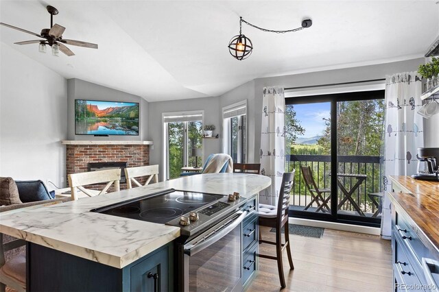 100 County Road 8344 Unit 3, Fraser, CO 80442 - kitchen featuring stainless steel range with electric cooktop, lofted ceiling, open floor plan, light wood-style flooring, and plenty of natural light