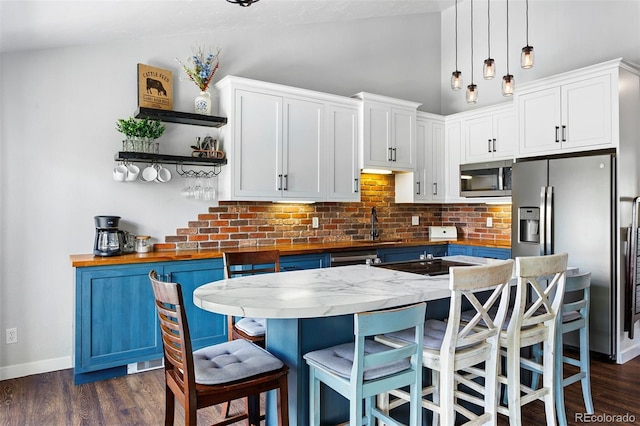 100 County Road 8344 Unit 3, Fraser, CO 80442 - kitchen featuring appliances with stainless steel finishes, open shelves, tasteful backsplash, white cabinets, and hanging light fixtures