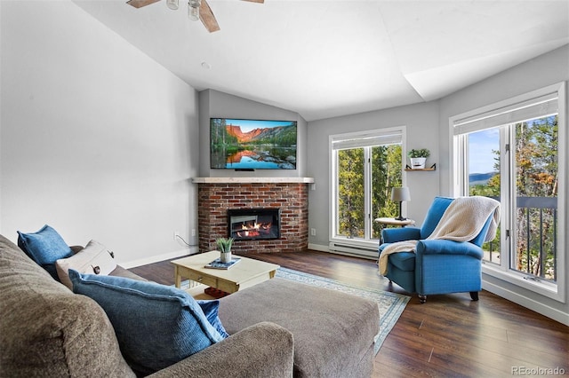 100 County Road 8344 Unit 3, Fraser, CO 80442 - living room with vaulted ceiling, wood finished floors, a baseboard radiator, a fireplace, and a ceiling fan