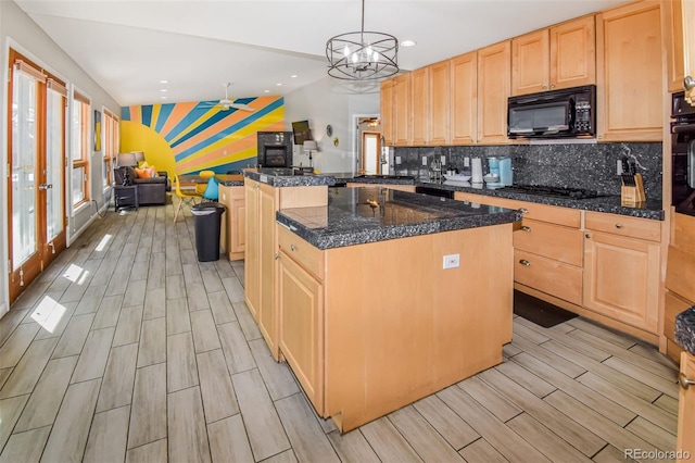 kitchen featuring light brown cabinetry, black appliances, a center island, and hanging light fixtures