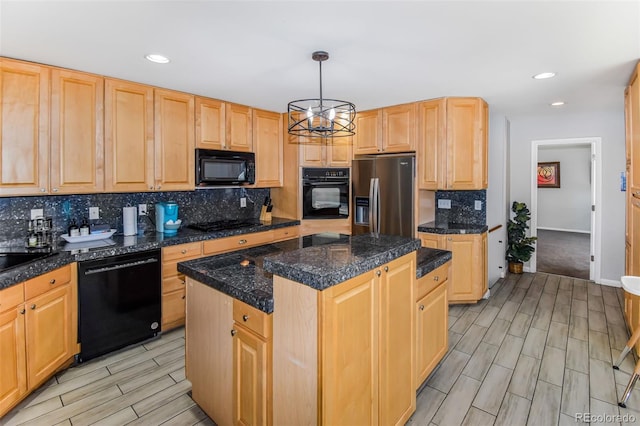 kitchen with light brown cabinets, tasteful backsplash, a kitchen island, decorative light fixtures, and black appliances