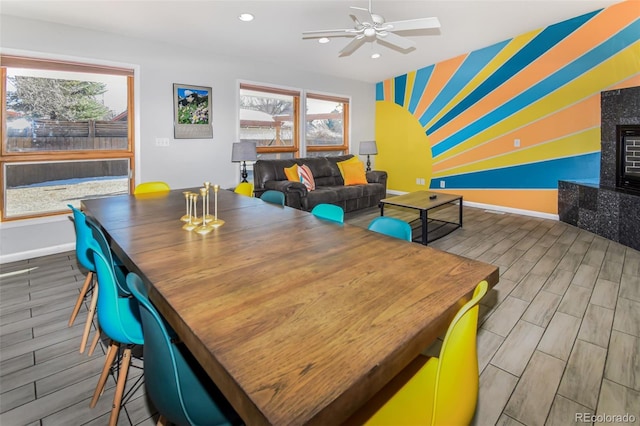 dining space featuring a healthy amount of sunlight, ceiling fan, and hardwood / wood-style flooring