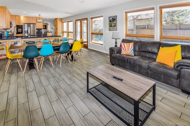 living room with lofted ceiling, light hardwood / wood-style floors, and a healthy amount of sunlight