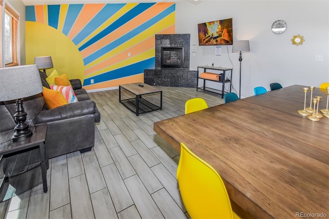 living room with light wood-type flooring and a premium fireplace