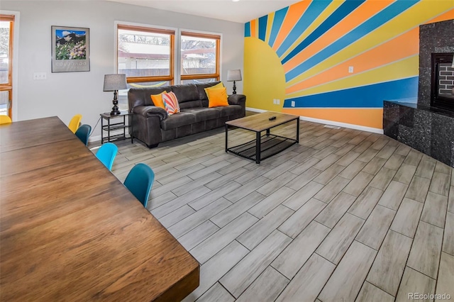 living room featuring light hardwood / wood-style floors and a high end fireplace