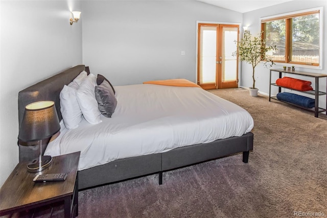 carpeted bedroom featuring vaulted ceiling and french doors