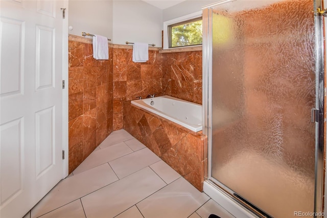 bathroom featuring tile walls, tile patterned flooring, and plus walk in shower