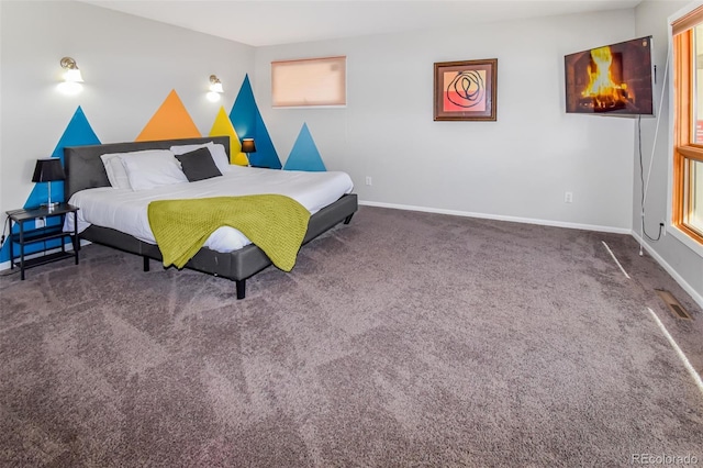 carpeted bedroom with multiple windows