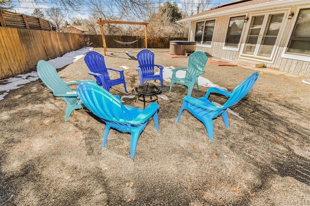 view of patio with a fire pit and a hot tub