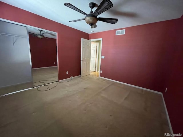 unfurnished bedroom with light carpet, a closet, and ceiling fan