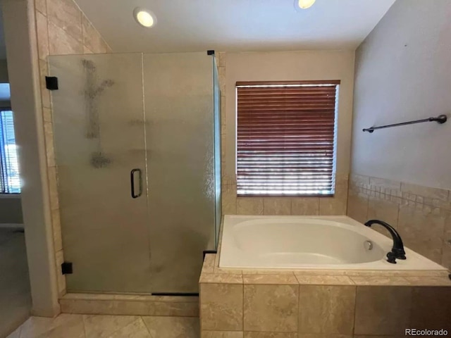 bathroom featuring shower with separate bathtub and plenty of natural light