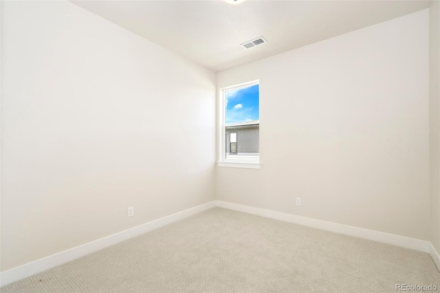 empty room with light carpet, baseboards, and visible vents