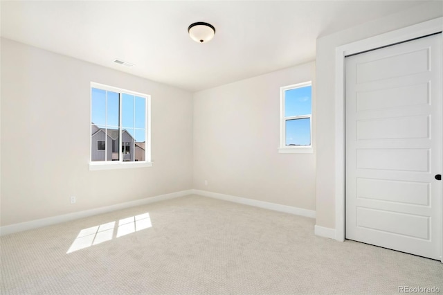 unfurnished bedroom with baseboards, a closet, visible vents, and carpet