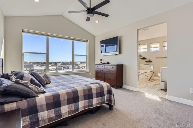 bedroom featuring ensuite bath, ceiling fan, vaulted ceiling, and light carpet