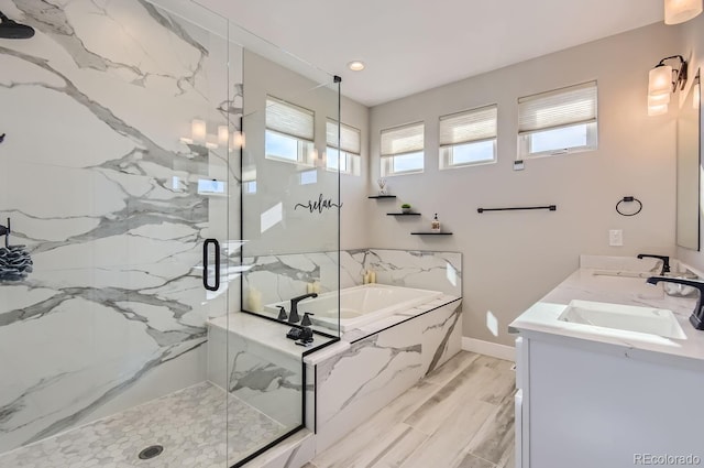 bathroom with hardwood / wood-style flooring, vanity, and shower with separate bathtub