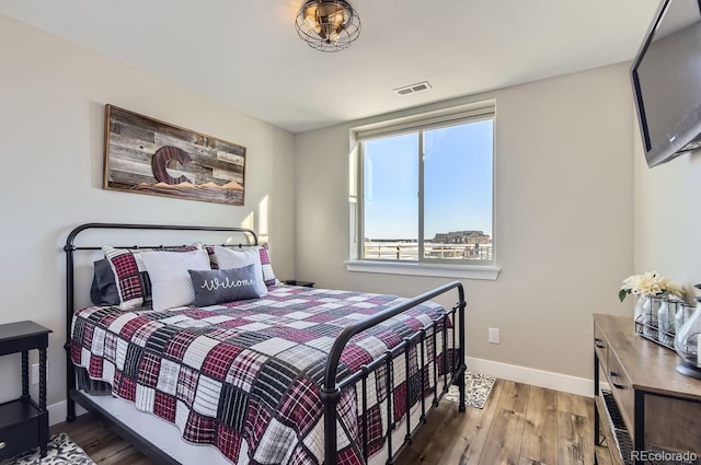 bedroom with hardwood / wood-style floors