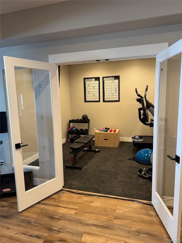 workout room with french doors and wood-type flooring