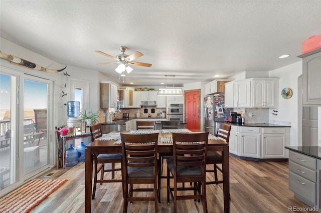 38087 E 147th Pl, Keenesburg, CO 80643 - dining area with dark wood-style floors, ceiling fan, recessed lighting, and a textured ceiling