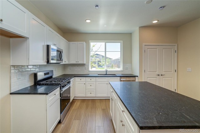 23951 E 40th Ave, Aurora, CO 80019 - kitchen featuring appliances with stainless steel finishes, a sink, light wood-type flooring, white cabinetry, and recessed lighting