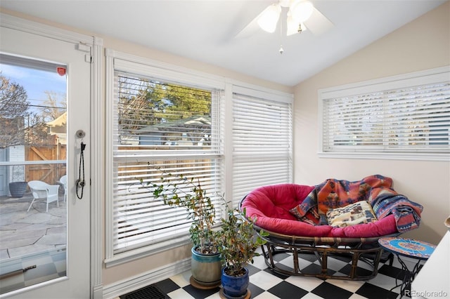 interior space with vaulted ceiling, a healthy amount of sunlight, and tile patterned floors