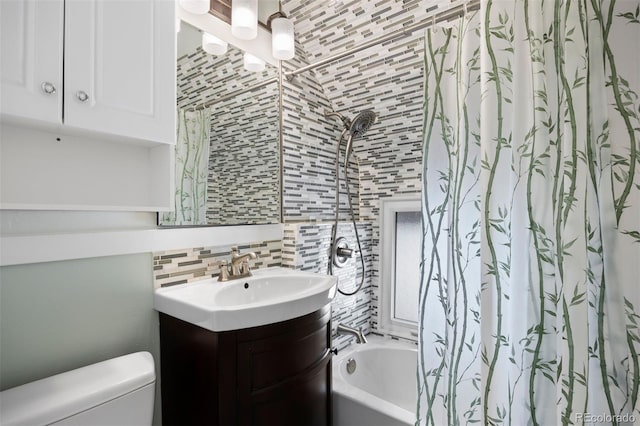 bathroom with shower / tub combo, vanity, toilet, and decorative backsplash