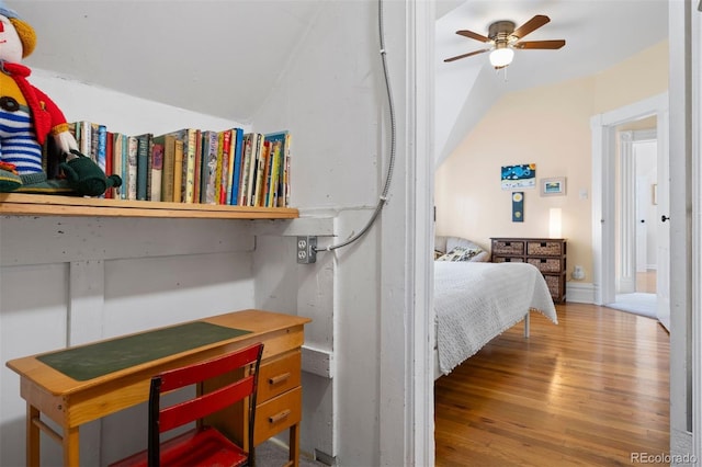 bedroom featuring lofted ceiling and wood finished floors