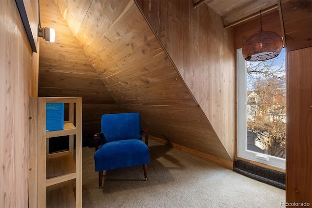 living area with carpet floors and wood walls