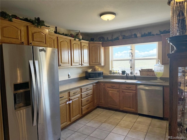 1970 County Road 241, Westcliffe, CO 81252 - kitchen with stainless steel appliances, a sink, light tile patterned flooring, and brown cabinets