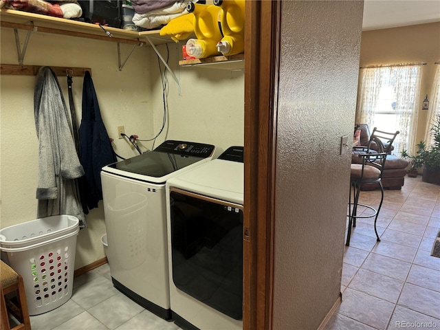 1970 County Road 241, Westcliffe, CO 81252 - laundry room featuring washer and dryer, light tile patterned flooring, and a textured wall