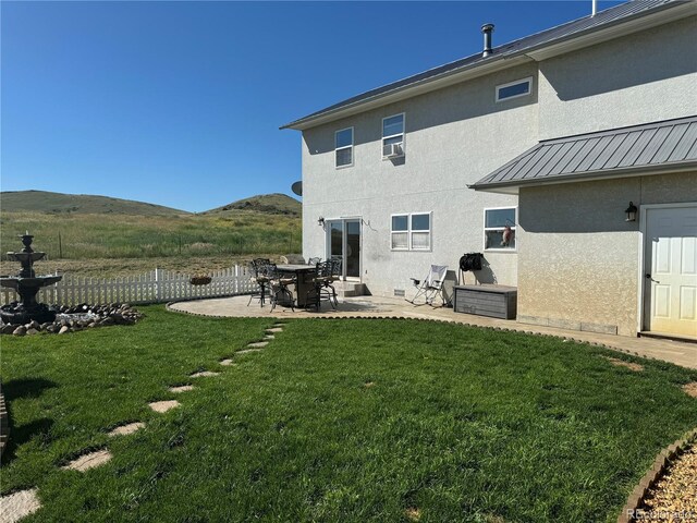 1970 County Road 241, Westcliffe, CO 81252 - back of house with a patio, stucco siding, a standing seam roof, a mountain view, and metal roof