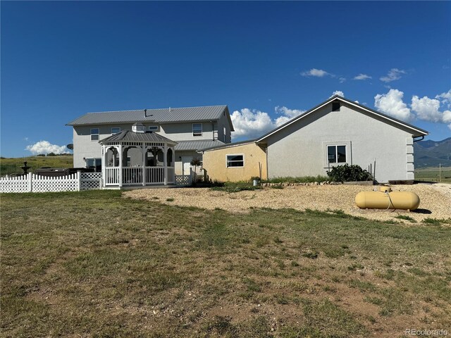 1970 County Road 241, Westcliffe, CO 81252 - rear view of house featuring a gazebo, stucco siding, and metal roof