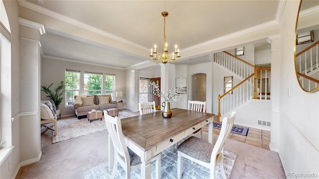 2521 Otter Ct, Lafayette, CO 80026 - carpeted dining room with a chandelier, stairs, ornate columns, arched walkways, and ornamental molding