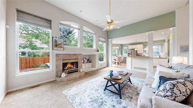 2521 Otter Ct, Lafayette, CO 80026 - living area with healthy amount of natural light, light colored carpet, and a tiled fireplace