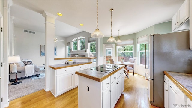 2521 Otter Ct, Lafayette, CO 80026 - kitchen with black electric cooktop, light wood-style floors, white cabinetry, a center island, and recessed lighting