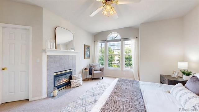 2521 Otter Ct, Lafayette, CO 80026 - bedroom with light colored carpet, a tiled fireplace, vaulted ceiling, and a ceiling fan