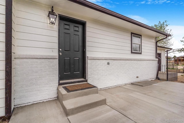 view of exterior entry with fence