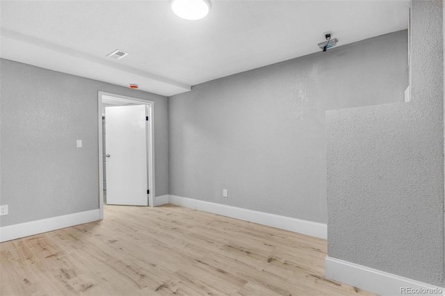 empty room with baseboards and wood finished floors