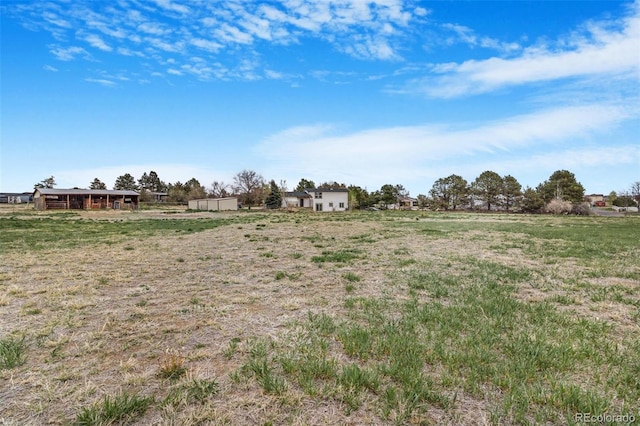 view of yard with a rural view