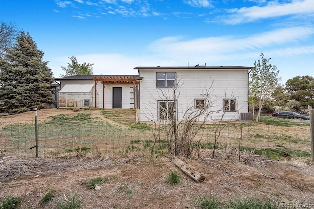 back of property with central AC unit, an exterior structure, and an outbuilding
