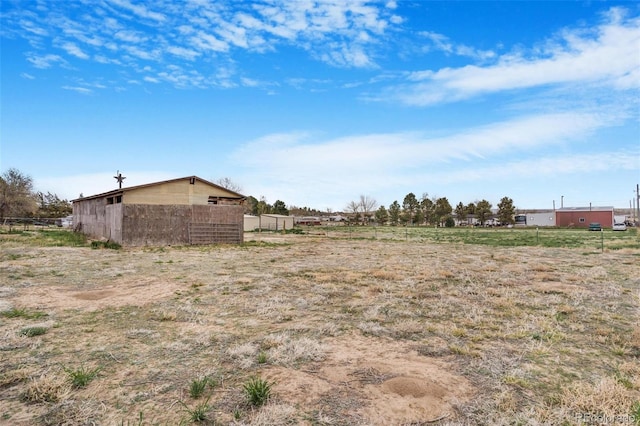 view of yard featuring fence and a rural view