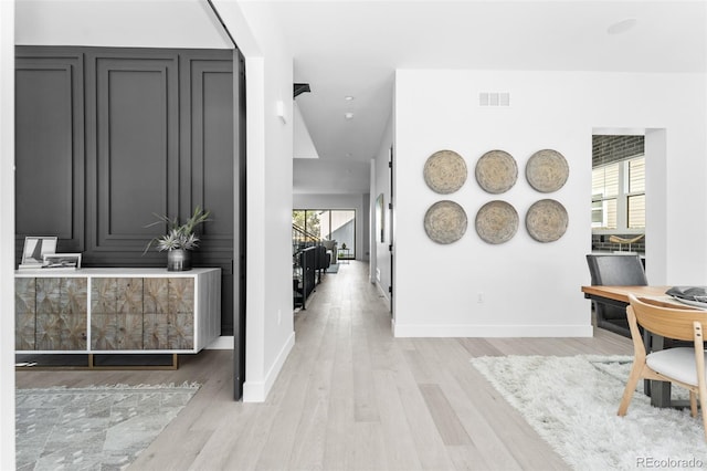 hallway with light hardwood / wood-style flooring