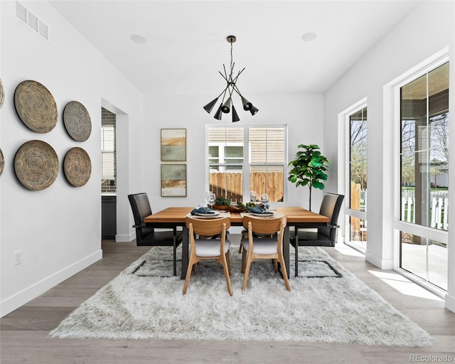 dining space featuring a wealth of natural light and light hardwood / wood-style floors