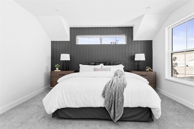 carpeted bedroom with lofted ceiling and multiple windows