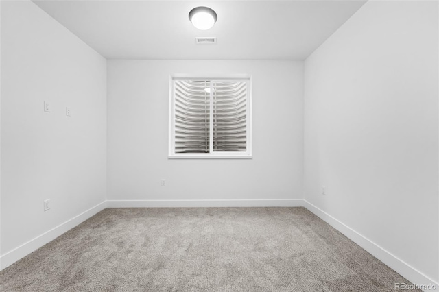 unfurnished room with light carpet