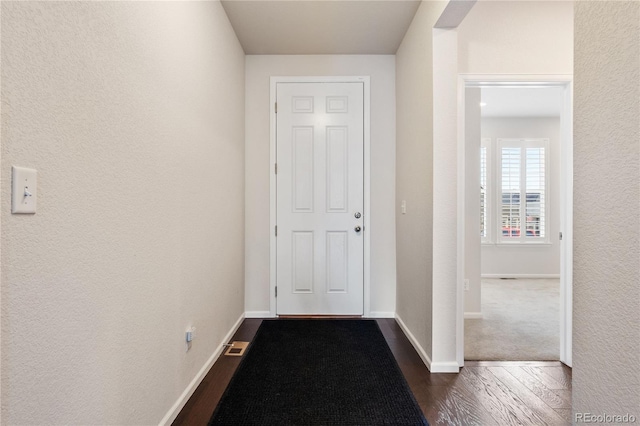 hallway with dark hardwood / wood-style flooring