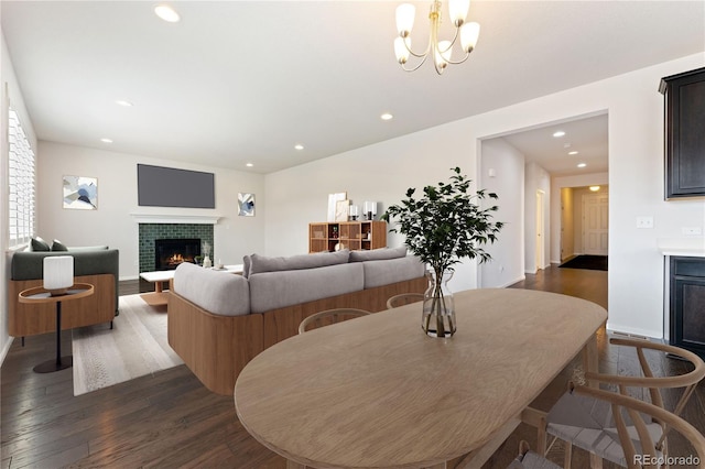 dining area featuring dark wood-type flooring and a chandelier