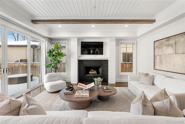 living room with a large fireplace, beam ceiling, wood finished floors, and recessed lighting