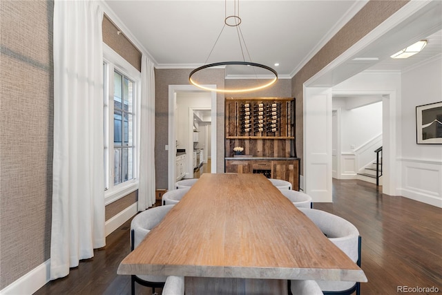 wine cellar with dark wood-type flooring and crown molding