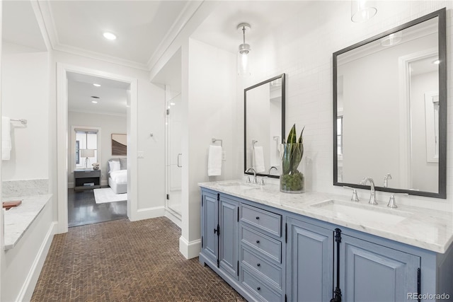 full bath featuring double vanity, connected bathroom, ornamental molding, and a sink